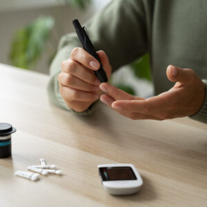 Picture of a woman pricking her finger for a glucose meter