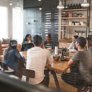 Group of men and women around a table in a discussion