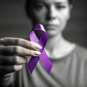 Black and white photo of a woman holding a vivid purple ribbon